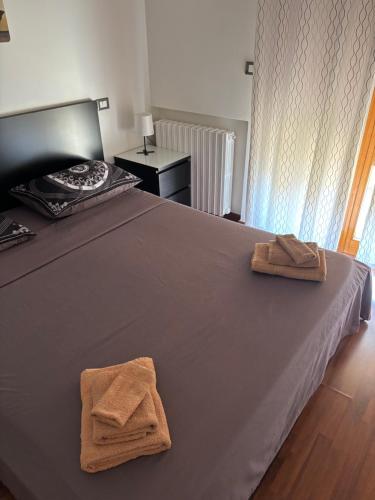 a bedroom with a bed with two towels on it at Dimora 14 in Termoli