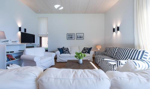 a living room with two white couches and a table at Cottage am See - Your Austrian Home in Mondsee