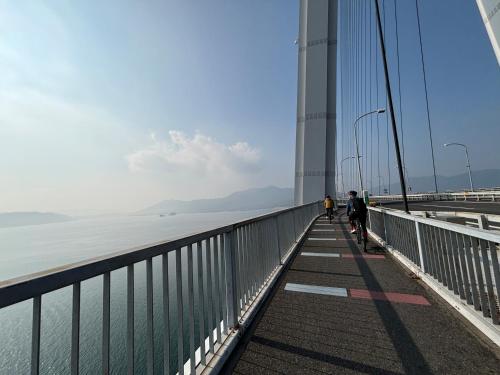 two people walking across the golden gate bridge at farm and bed SETODA in Onomichi