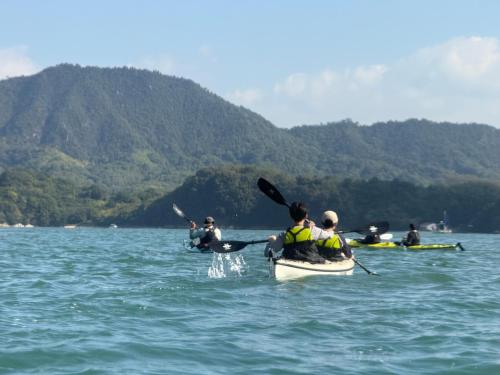 a group of people in kayaks in the water at farm and bed SETODA in Onomichi