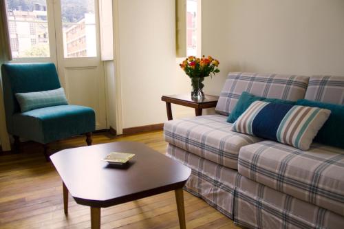 a living room with a couch and two chairs and a table at Hotel Casa de la Vega in Bogotá