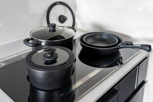 two pots and pans sitting on top of a stove at Violet Garden in Furano