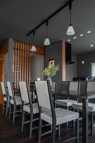 a dining room with a table and chairs at Violet Garden in Furano