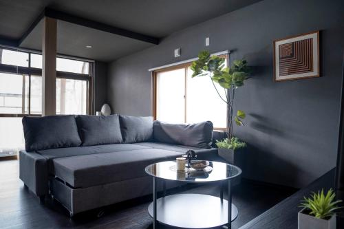 a living room with a couch and a table at Violet Garden in Furano