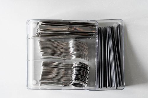 a clear plastic container filled with forks and spoons at Violet Garden in Furano