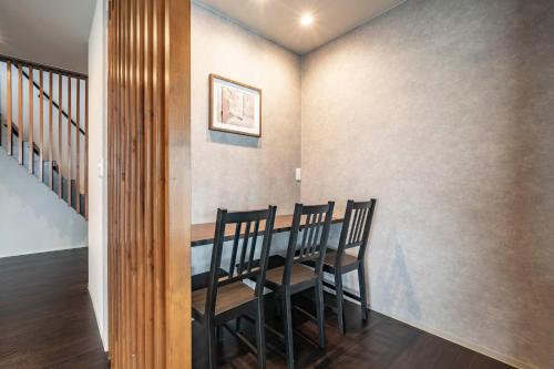 a dining room with a table and chairs at Violet Garden in Furano