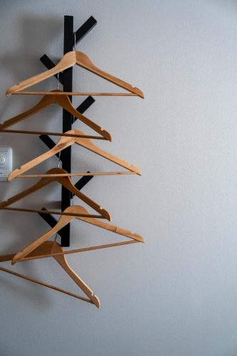 a wooden shelf with many woodensticks on a wall at Violet Garden in Furano