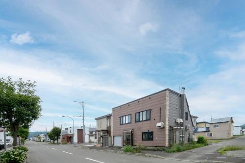 a brick building on the side of a street at Violet Garden in Furano