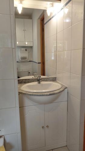 a white bathroom with a sink and a mirror at Gite Mimosa - Private Pool, Sainte-Valière, South of France in Sainte-Vallière