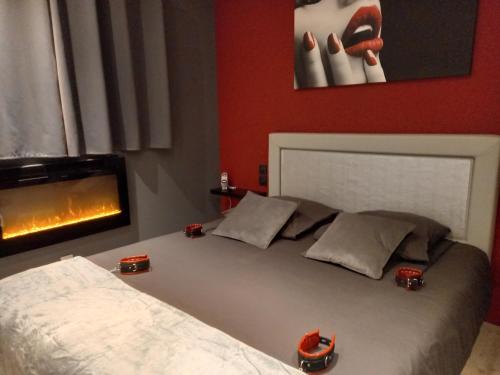 a bedroom with a bed and a fire place at L'Envol de Séléné - LOVE ROOM in Carcassonne