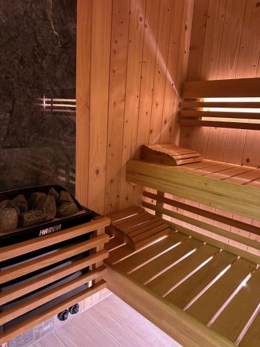 a sauna with wooden walls and logs in it at 't Veurhuus in Ansen
