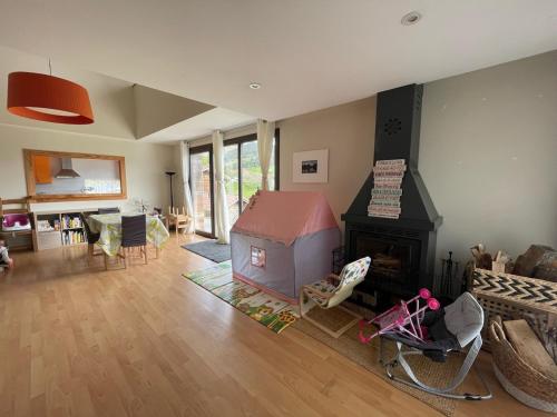a living room with a fireplace and a living room with at Espaciosa con vistas in Villaviciosa