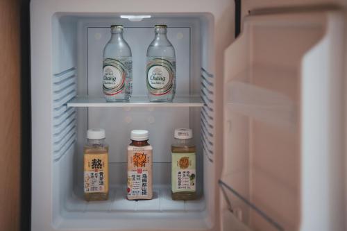 a refrigerator filled with bottles of milk and honey at PingYao Chengfu Jinyuan Hotel in Pingyao
