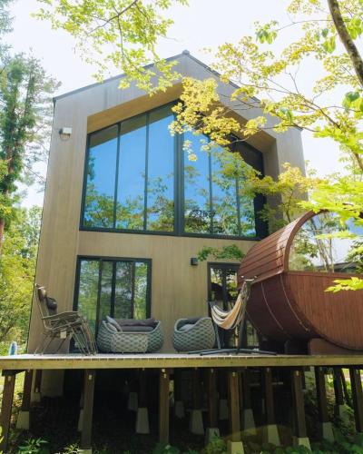 a small house with a large boat on the deck at Hakuba Hibiku Chalet by Jade Group in Hakuba