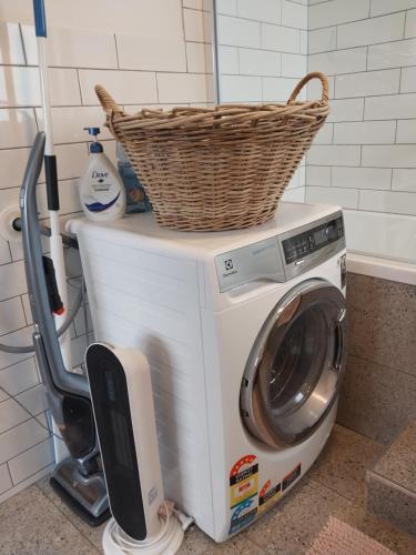 a washing machine with a basket on top of it at Studio Solaris in Daylesford