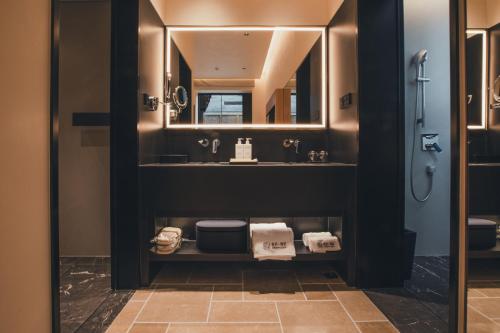 a bathroom with a sink and a mirror at PingYao Chengfu Jinyuan Hotel in Pingyao