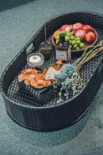 a table with fruits and vegetables in a black basket at PingYao Chengfu Jinyuan Hotel in Pingyao