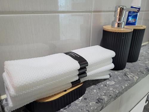 a pile of towels sitting on a counter in a bathroom at Busan Station KTX 30s Ocean View 부산역ktx 30초 오션뷰 in Busan