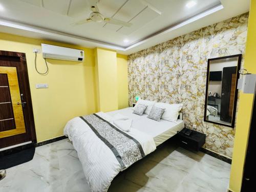 a bedroom with a bed in a yellow room at HOTEL HYDERABAD PULSE in Shamshabad