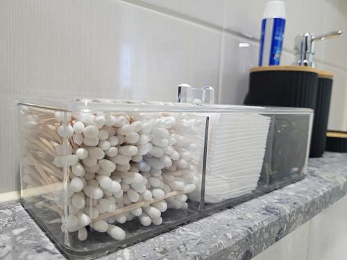 a glass container filled with white balls on a counter at Busan Station KTX 30s Ocean View 부산역ktx 30초 오션뷰 in Busan