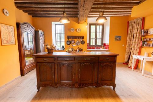 a kitchen with an island in the middle of a room at Seigneurie de Baulne in Baulne-en-Brie
