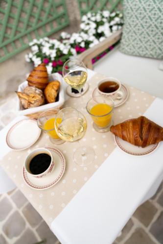 a table topped with glasses of wine and bread at Le Clos Haton - HAUTVILLERS in Hautvillers