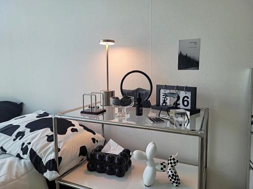 a bedroom with a bed and a glass table with cosmetics at Busan Station KTX 30s Ocean View 부산역ktx 30초 오션뷰 in Busan