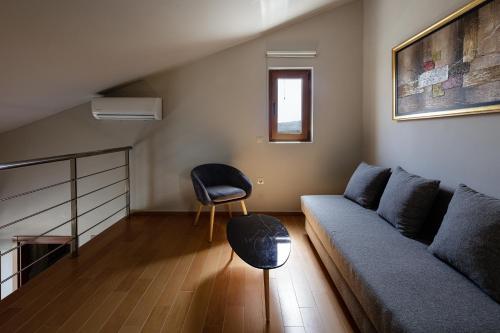 a living room with a couch and a chair at Alpha Estate & Spa in Rethymno Town