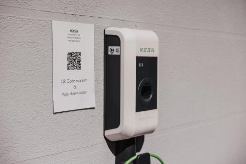 a parking meter is attached to a wall at Ewitsch 13 - Hotel Garni in Berghausen
