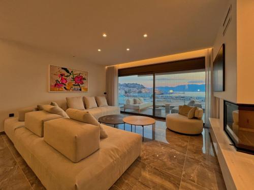 a living room with a couch and a fireplace at FOS Luxury Apartment with View of Nafplio in Nafplio