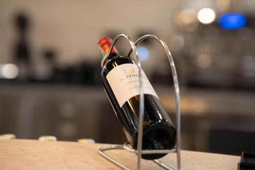 a bottle of wine in a holder on a table at Treetop by Eight Continents, Zanzibar in Mchangani