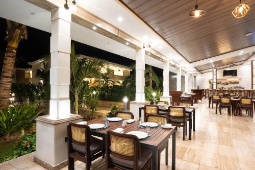 a dining room with tables and chairs in a restaurant at Treetop by Eight Continents, Zanzibar in Mchangani