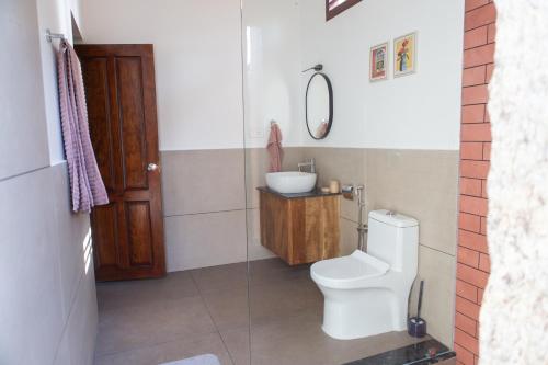 a bathroom with a toilet and a sink at Eema Homestay Marari in Mararikulam