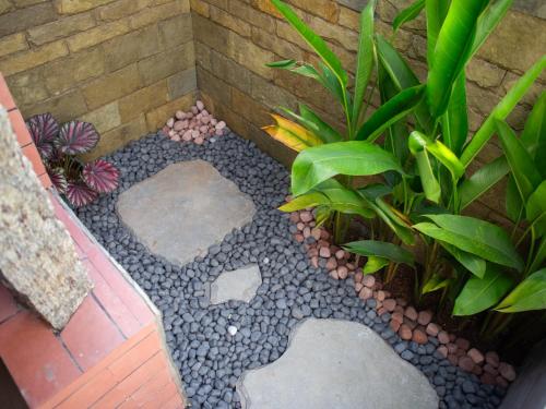 a garden with rocks and plants on a patio at Eema Homestay Marari in Mararikulam
