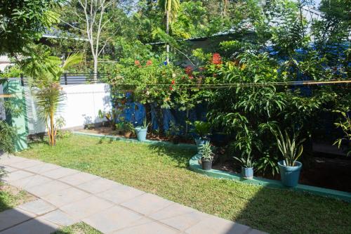a garden with potted plants on a fence at Eema Homestay Marari in Mararikulam