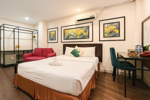 a hotel room with a bed and a desk at Hoang Phi Saigon Hotel & Spa in Ho Chi Minh City