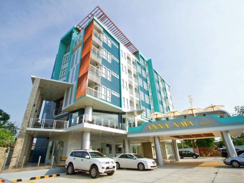 a building with cars parked in front of it at Anna-Nava Pakkret Hotel in Nonthaburi