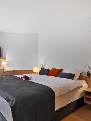 a bedroom with a large bed with flowers on it at Centra Hotel Zurich in Bassersdorf