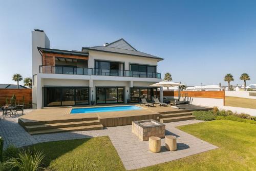 a large house with a swimming pool in a yard at 1442 Marina by Double Portion in Jeffreys Bay