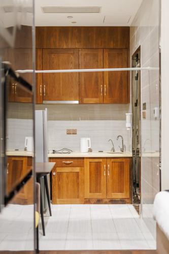 a kitchen with wooden cabinets and a sink at SEEU Designer Apartment in Shenzhen