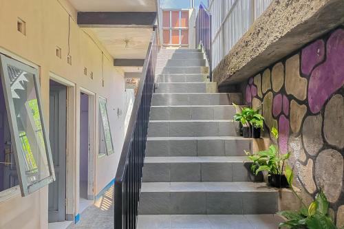 a staircase leading up to a building with plants at RedDoorz near Treetop Adventure Kopeng in Kopeng