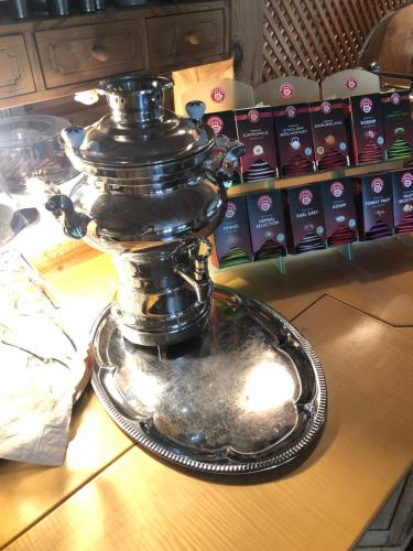 a silver urn sitting on top of a table at Hotel St. Ulrich Garni in Ottobeuren