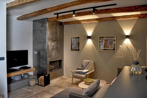 a living room with a table and a fireplace at Villa Zita with private pool and sauna in Potpićan