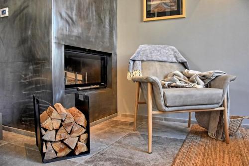 a living room with a chair and a fireplace at Villa Zita with private pool and sauna in Potpićan