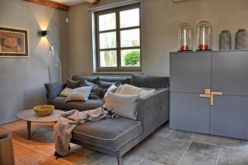 a living room with a couch and a table at Villa Zita with private pool and sauna in Potpićan