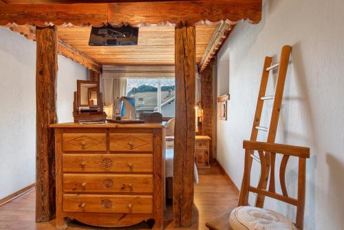 a bedroom with a dresser and a bed and a ladder at Affittacamere Jour Et Nuit in Torgnon