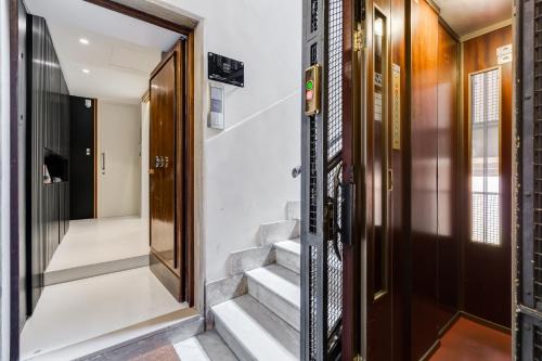 a door leading to a hallway with stairs at Sora Luxury Inn in Rome