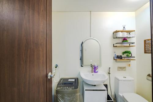 a bathroom with a sink and a toilet at Pioneer Woodlands Tower 5 Unit 33-Q in Manila