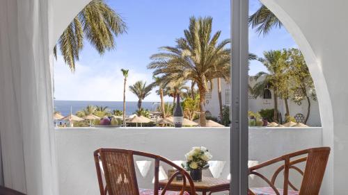 a view of the ocean from the balcony of a resort at Domina Coral Bay Resort, Diving , Spa & Casino in Sharm El Sheikh