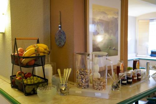 a counter with fruits and other food items on it at Apart Hotel Leipzig Taucha in Taucha